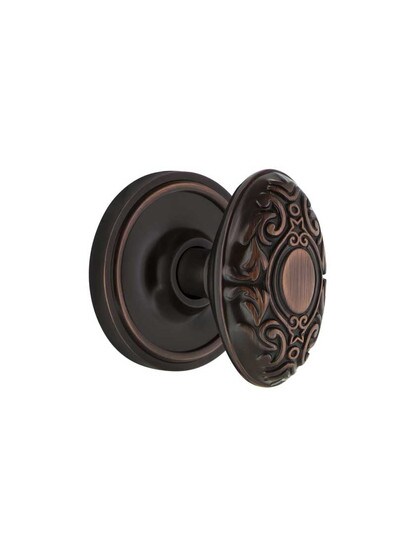 Classic Rosette Mortise Lock Set With Decorative Oval Knobs in Timeless Bronze.